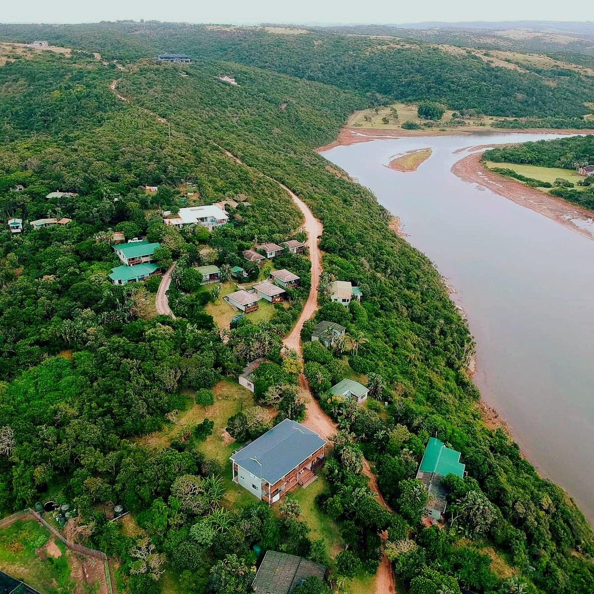 Aerial view of Buccaneers Beach Lodge nestled in forest alongside the Chintsa lagoon