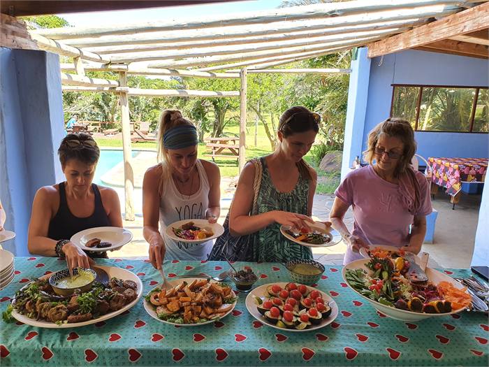 Guests having lunch at tables beside the swimming pool