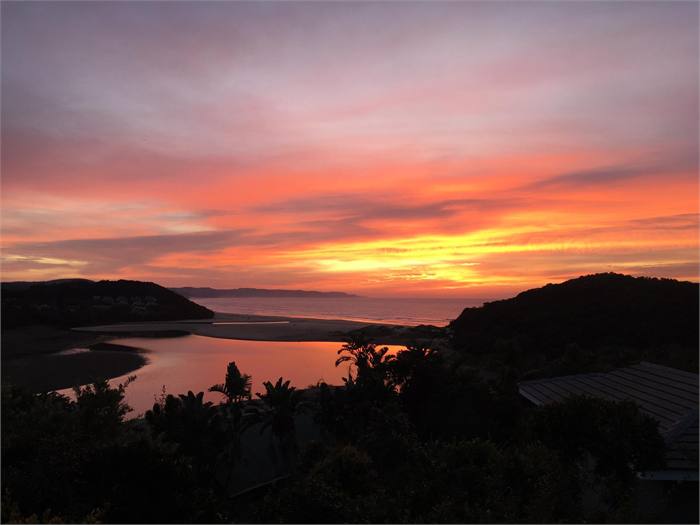 Pink and orange sunrise over the Chintsa lagoon