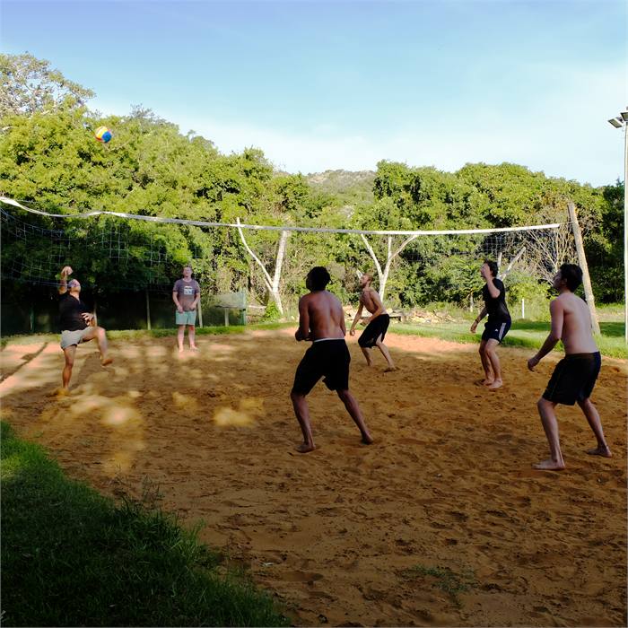 A game of beach volleyball on the court at the lodge