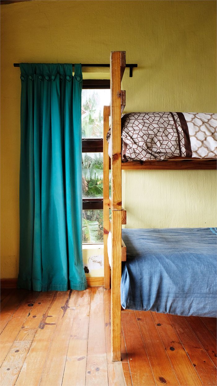 Wooden bunk beds with linen in the Blue Dorm at Buccaneers